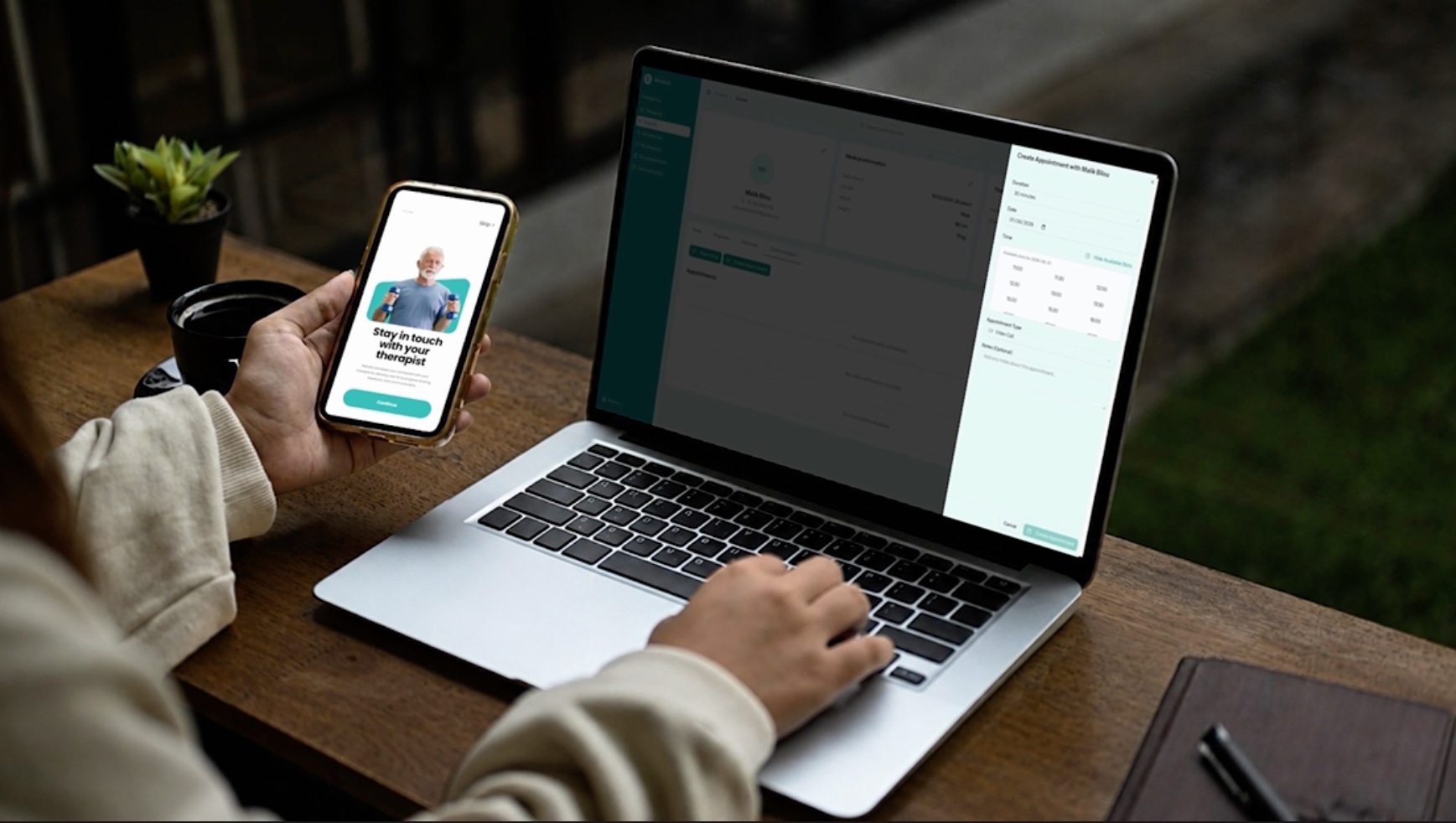 Therapist scheduling an appointment in the RehabLab web app on a laptop, holding a phone with the RehabLab patient app